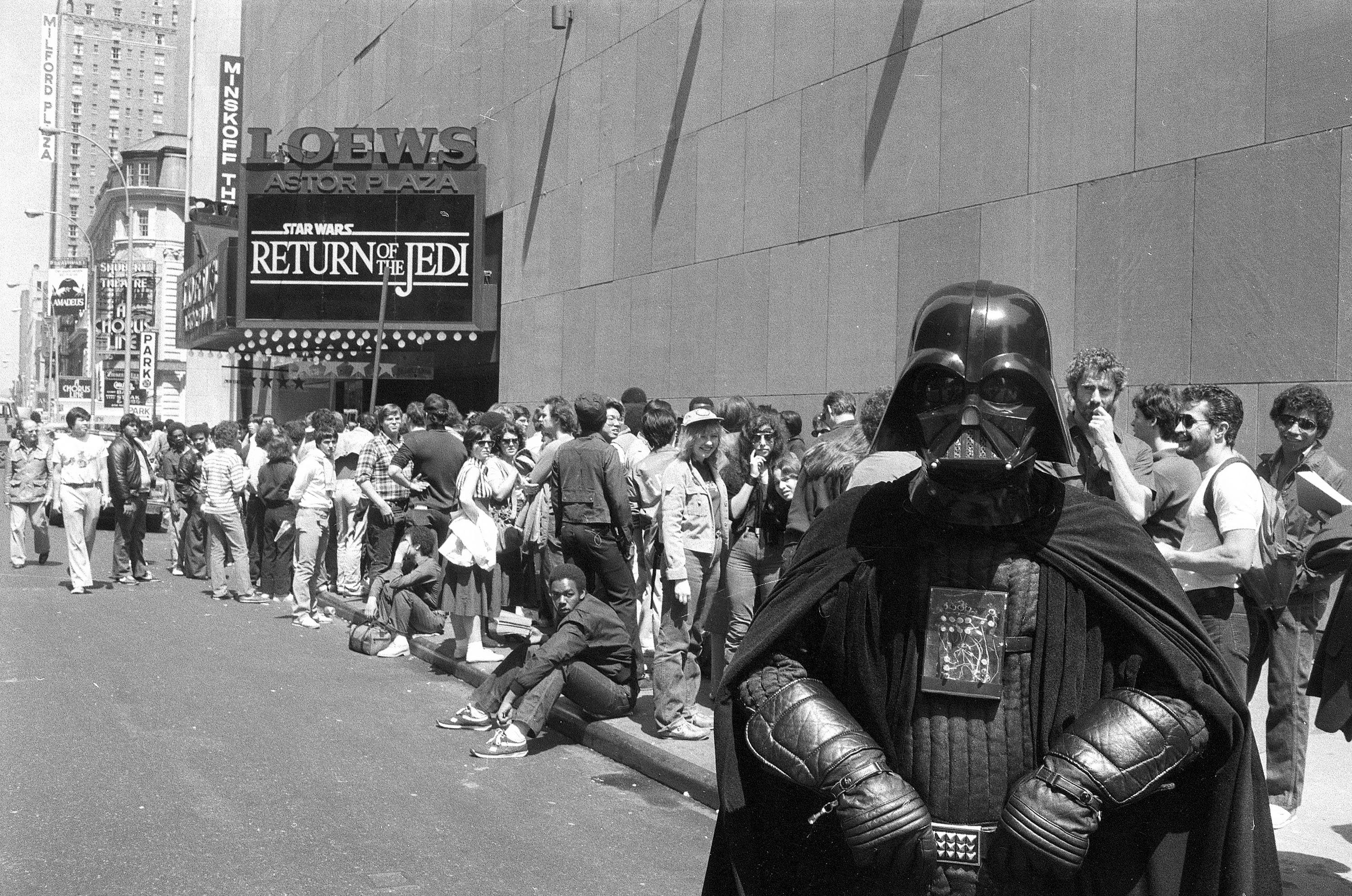 "Star Wars" fan Danny Fitzgerald of Staten Island, in Darth Vader costume, poses in front of Loews Astor Plaza movie theater in Times Square in New York, May 25, 1983, where fans are lined up for the premiere of "The Return of the Jedi," the third in a series of the "Star Wars" saga. (AP Photo/Dave Pickoff)